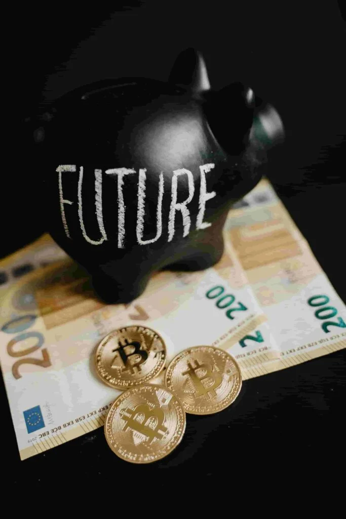 A black piggy bank with "FUTURE" written on it sits on top of a few Euro banknotes and three Bitcoin coins, representing financial security akin to insurance. The background is dark, emphasizing the piggy bank and the money.