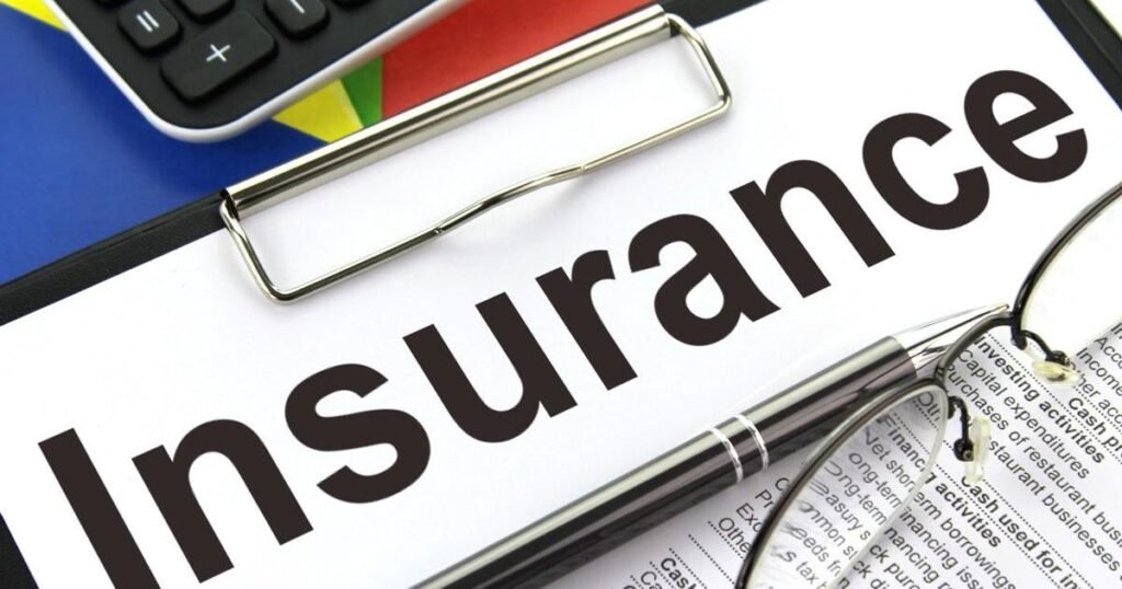 A clipboard holds a document labeled "Insurance" in large letters—perhaps Special Event Insurance—with a pen, glasses, and part of a calculator visible nearby.